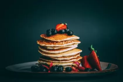 pancakes with strawberries and blueberries on top